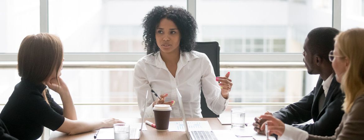 Horizontal photo african female boss talking at corporate meeting