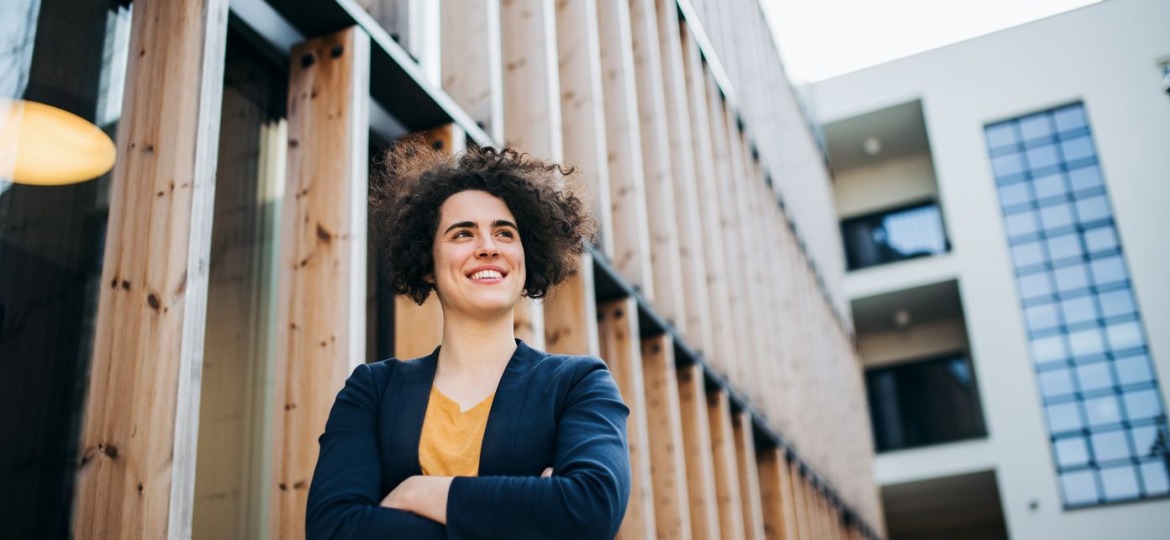 a-happy-young-business-woman-standing-outdoors-sm